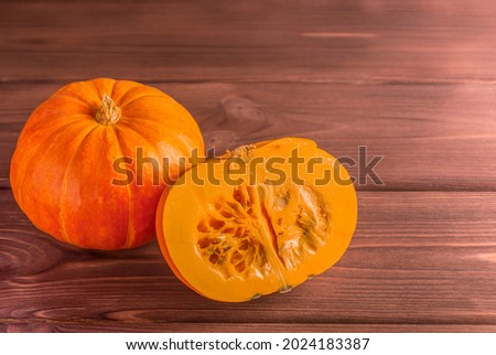 Raw fresh pumpkins on a wooden background. Copy space.