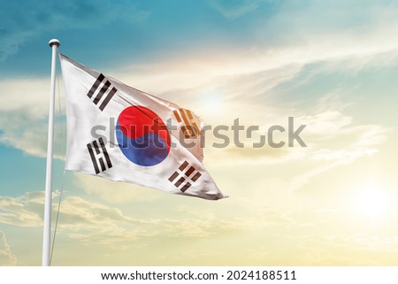 Korea South national flag waving in beautiful clouds. Royalty-Free Stock Photo #2024188511