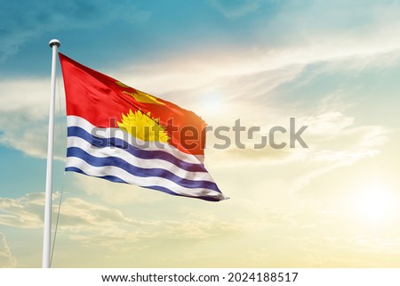 Kiribati national flag waving in beautiful clouds.