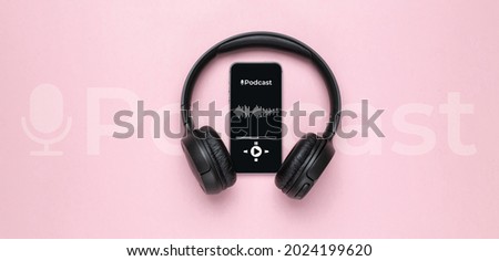 Podcast background. Mobile smartphone screen with podcast application, sound headphones. Audio voice with radio microphone on pink. Recording studio or podcasting banner with copy space Royalty-Free Stock Photo #2024199620