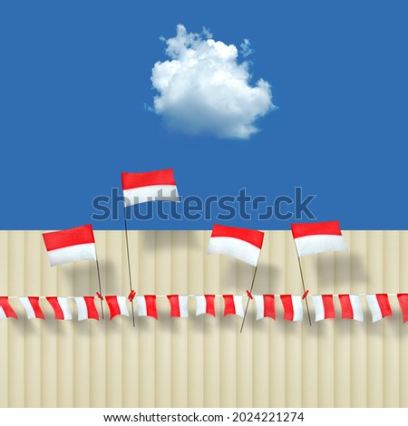 Indonesian flag made of textured paper, under white clouds