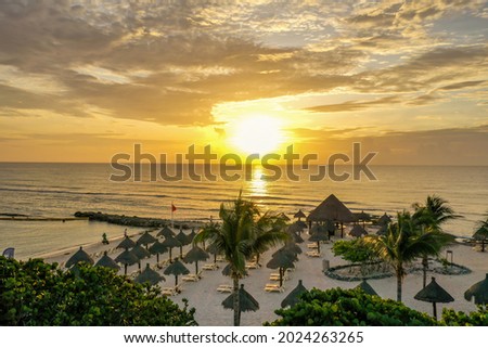 Sunrise on the Caribbean Sea. Beach line of the hotel.