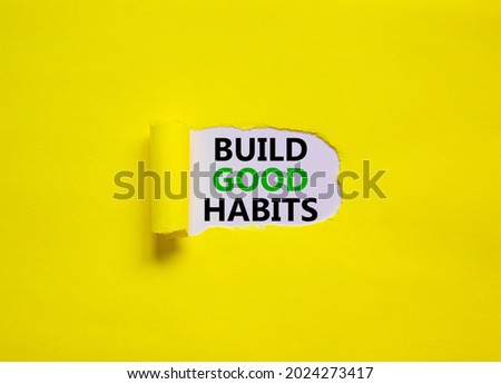 Build good habits symbol. Words 'Build good habits' appearing behind torn yellow paper. Beautiful yellow background. Business, psychology and build good habits concept, copy space.