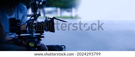 Video production behind the scenes. Making of TV commercial movie that film crew team lightman and cameraman working together with film director in studio. film production concept. Silhouette style. Royalty-Free Stock Photo #2024293799