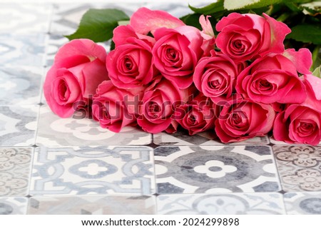 Pink roses on traditional portuguese floor tiles. 