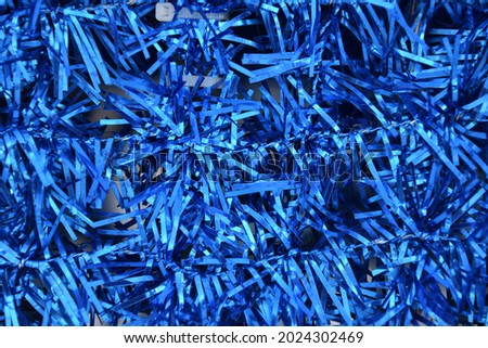 Background of vibrant blue glowing tinsel 
