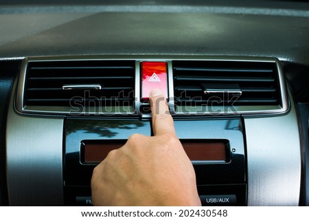 finger hitting car emergency light botton