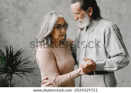 The happy elderly woman and a man dancing