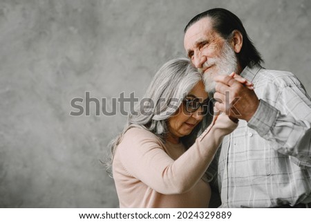 The happy elderly woman and a man dancing