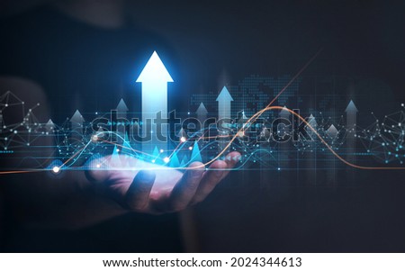 Businessman hand holding arrow up with graph of business analysis. Global business industry development. Business development, financial plan and  strategy Royalty-Free Stock Photo #2024344613