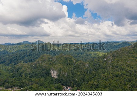 An aerial view of Madai caves in the tropical rainforest jungle of Borneo Sabah Malaysia. This Beautiful 40meters of waterfall located in Madai-Baturong Virgin Jungle Reserve in Kunak, Sabah.
