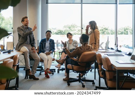 Group of Smiling Businesspeople in a Casual Meeting at their Company.

Team of five multi-ethnic employee having fun working together in an open plan office with big windows. Royalty-Free Stock Photo #2024347499