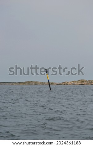 South cardinal mark black and yellow buoy at sea used for maritime navigation (vertical picture)