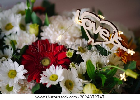 Flowers background with love is inscription decorated with led lights in star form