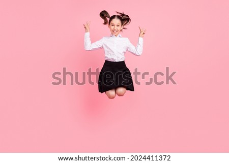 Full length photo of happy positive small girl jump up show v-sign cool isolated on pastel pink color background