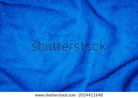 Cotton Terry blue towel background. Ocean blue Terry towel texture. Bath accessories concept.  Blue cloth background.
