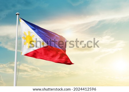 Philippines national flag waving in beautiful clouds.