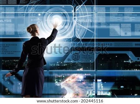 Rear view of businesswoman touching icon of digital screen