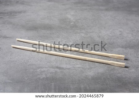 chopsticks for eating sushi on gray background