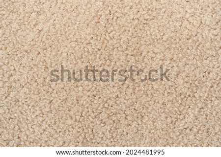 Beige  curly wool seamless texture background. texture with short factory material.