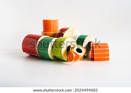 Multi-colored self-adhesive labels in label rolls for thermal transfer printer. Various forms for direct printing of your advertisement. Royalty-Free Stock Photo #2024494682