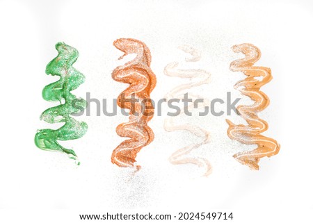Creative concept photo of cosmetics swatches beauty products face cream, concealer and face mask on white background.