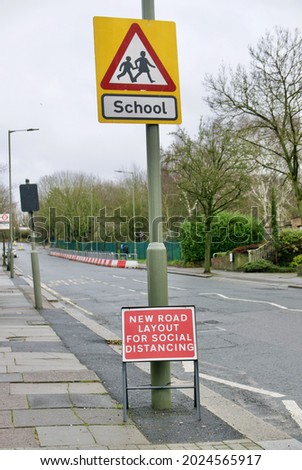A vertical shot of a warning sign about School children on the side of the street