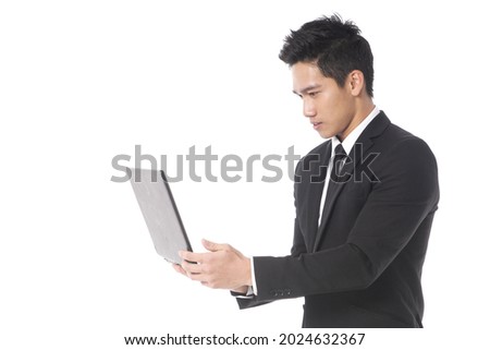 portrait of young businessman standing  use computer. Computer technology. Portable pc. Laptop or notebook. 
 posing in studio

