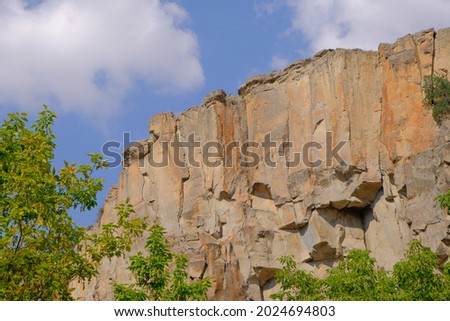 Huge stones  with blue sky background and behind trees in ihlara valley