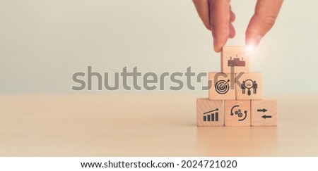 Benchmarking concept. Comparing business processes and performance. Man hold wooden cubes  performance, process, compare and target icon isolated on white background and copy space. Used for banner. Royalty-Free Stock Photo #2024721020