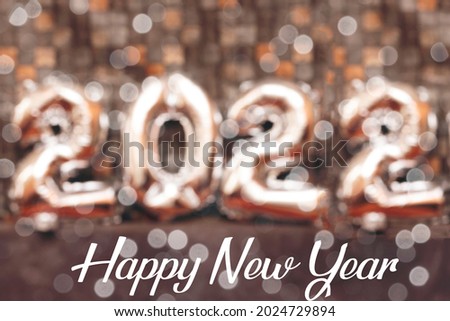 Happy New Year 2022 silver balloons with bokeh light