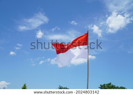 Indonesia's red and white flag flutters in the blue sky, Indonesia Independence Day Concept