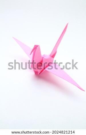 Cool pink folding crane "vertical composition" Royalty-Free Stock Photo #2024821214