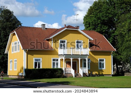 Traditional Swedish yellow wooden house Royalty-Free Stock Photo #2024843894