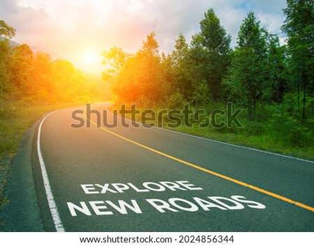 Explore new roads, concept photo of asphalt road. Encouraging quote on road. Summer forest landscape with curved highway. Inspirational quote banner or cover. Motivational card. Holiday concept