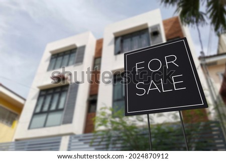 For sale sign in front of an affordable three storey apartment building. A medium density residential building on the real estate market.