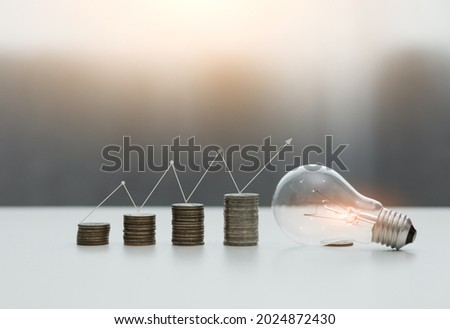 Light bulb Energy saving and a coin glass on the floor nature background with icons