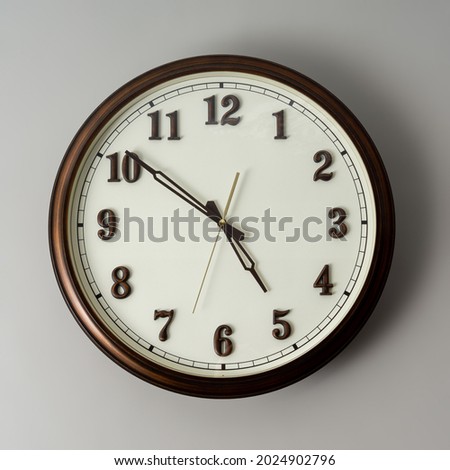 Wall clock on gray background.