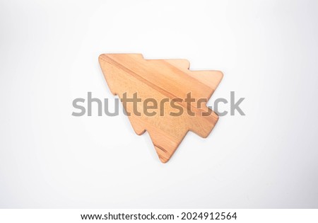 Wooden Christmas Tree shaped cutting board on white background service plate