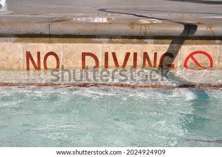 No Diving sign on the side of a swimming pool.