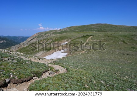 Alpine tundra above tree line on High Lonesome Trail in Indian Peaks Wilderness in Arapaho National Forest, Colorado on clear sunny summer afternoon. Royalty-Free Stock Photo #2024931779