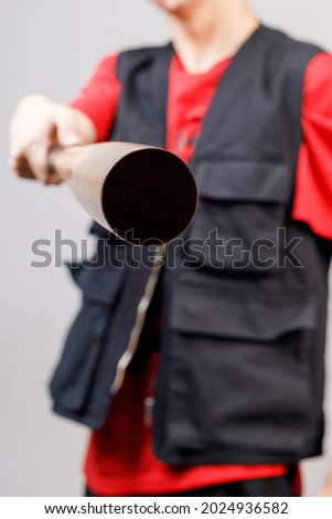 a baseball bat in the hands of a man aimed at the center of the frame. a dangerous man