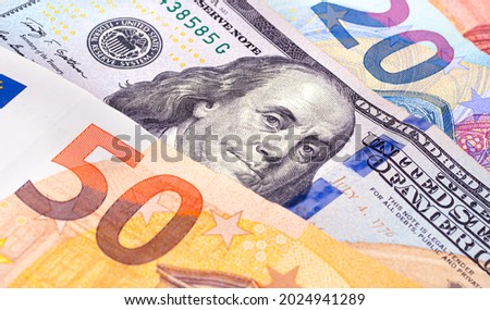 Exchange, cash. One hundred US dollar banknote among euro banknotes in closeup photography for foreign exchange market concept. Royalty-Free Stock Photo #2024941289