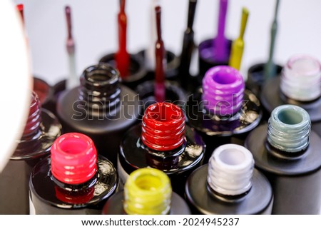 Multi-colored gel varnishes for manicure and pedicure close-up. Materials for a beauty salon. Colored novelties for the 2021 season. Horizontal photo of objects.