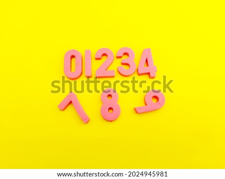 Closeup of puzzle in the form of numbers on yellow background with blank space for text.