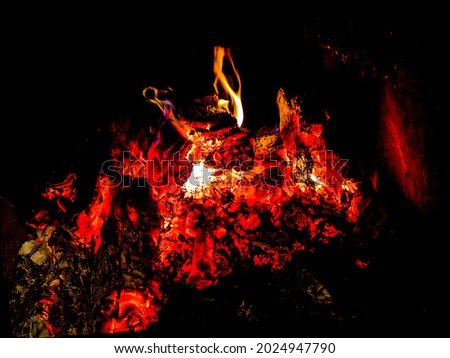Fire in burning the hearth .  Firewood smolder in fireplace. Ashes and embers in fireplace