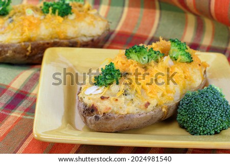 Cheddar cheese and broccoli stuffed baked potatoes. Royalty-Free Stock Photo #2024981540