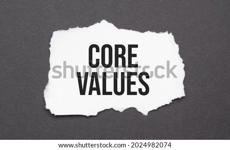 core values sign on the torn paper on the black background