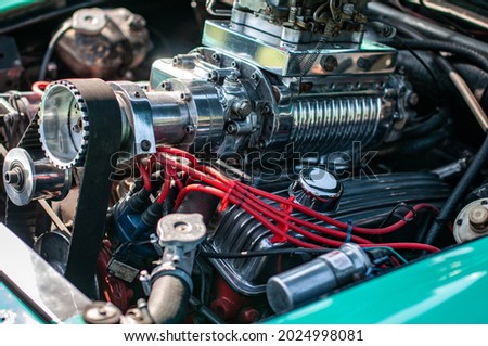 Classic car engine accompanied by a huge supercharger. Royalty-Free Stock Photo #2024998081