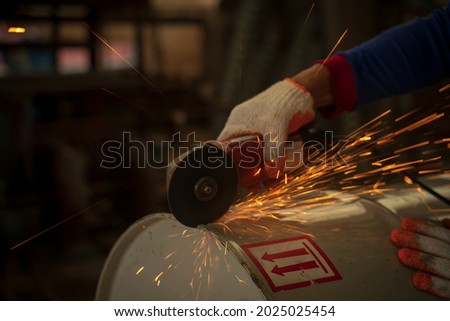 Electric wheel grinding on steel structure in factory.Flame sparks with electric grinder Change the swaying back and forth all the time.

Gloved worker with a grinder cuts a carbide plate 